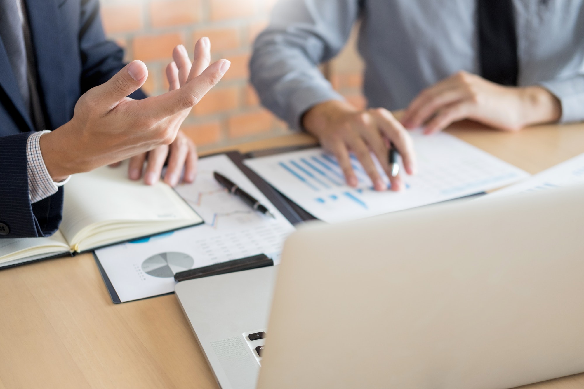 Businessmen talking about stock market invest trading online analysis discussing financial graph for