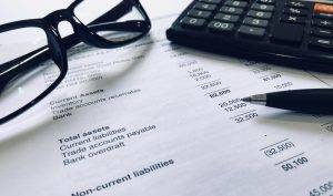 Accounting concept. Calculator and balance sheet