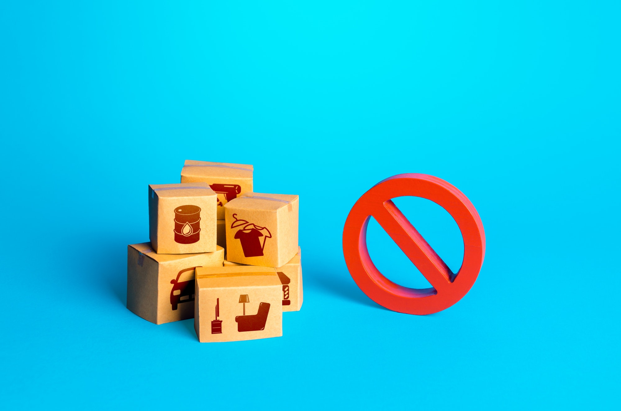 Boxes with goods and a red prohibition sign NO. Restrictions on import of products. Obstacles